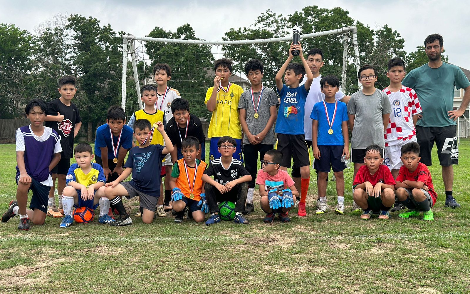 Children from the Saba Center Sunday Soccer League on the pitch during a weekend match.